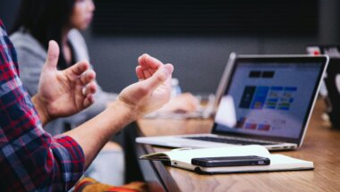 colleagues discussing the benefits and unique selling points of their SaaS product.