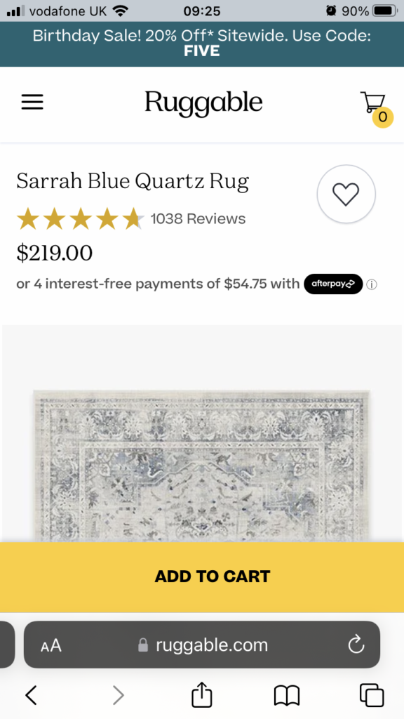 Screenshot example of Ruggable's bright, bold and yellow add to cart button.